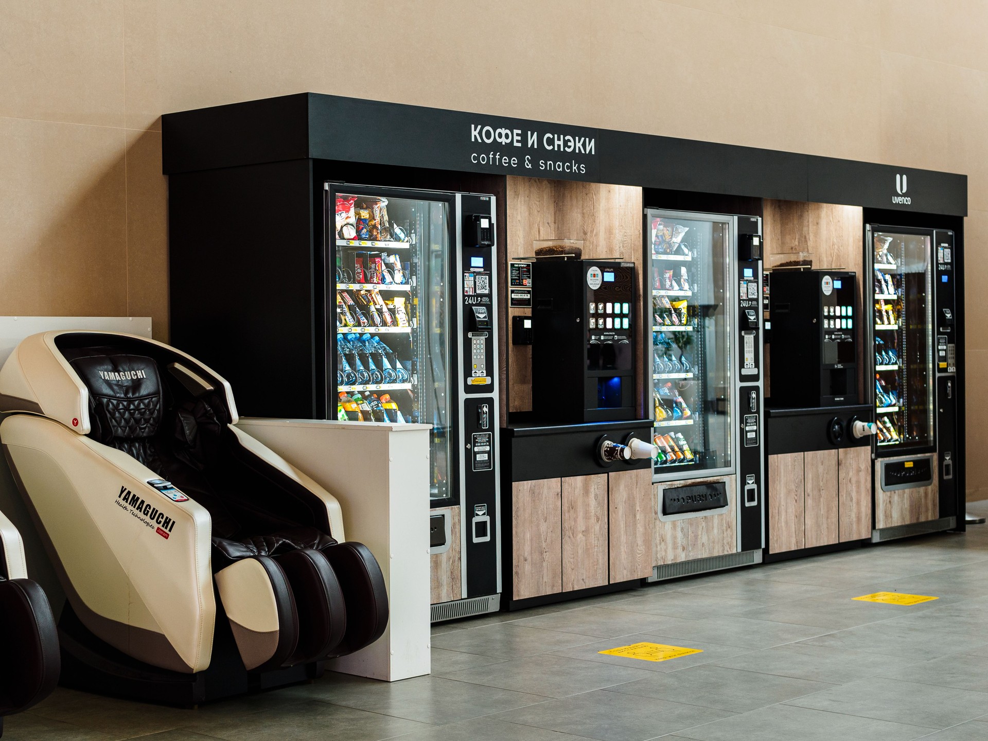 vending machine for soft drinks, coffee and snacks, massage chair in the waiting room of Platov International Airport